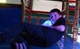 Boy climbing through a colourful soft play area