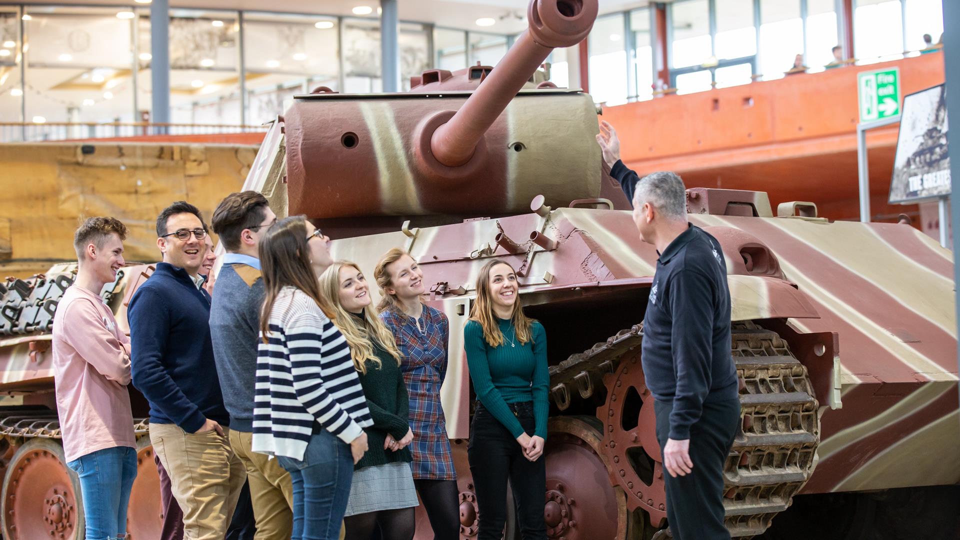 Man giving tour and talk about Tanks in museum