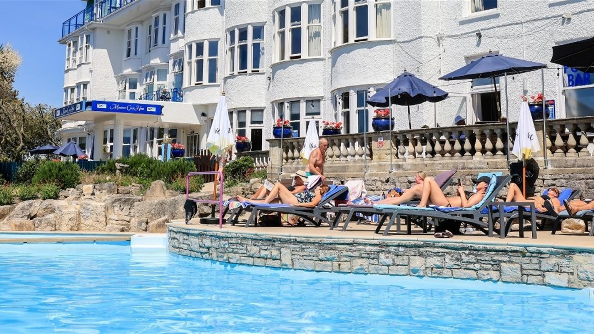 Guests soacking up the sun poolisde at the Marsham Court Hotel