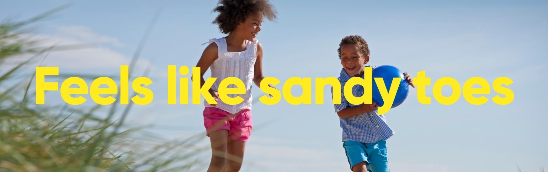 Kids playing on the beach with a ball with text that reads "Feels like sandy toes"