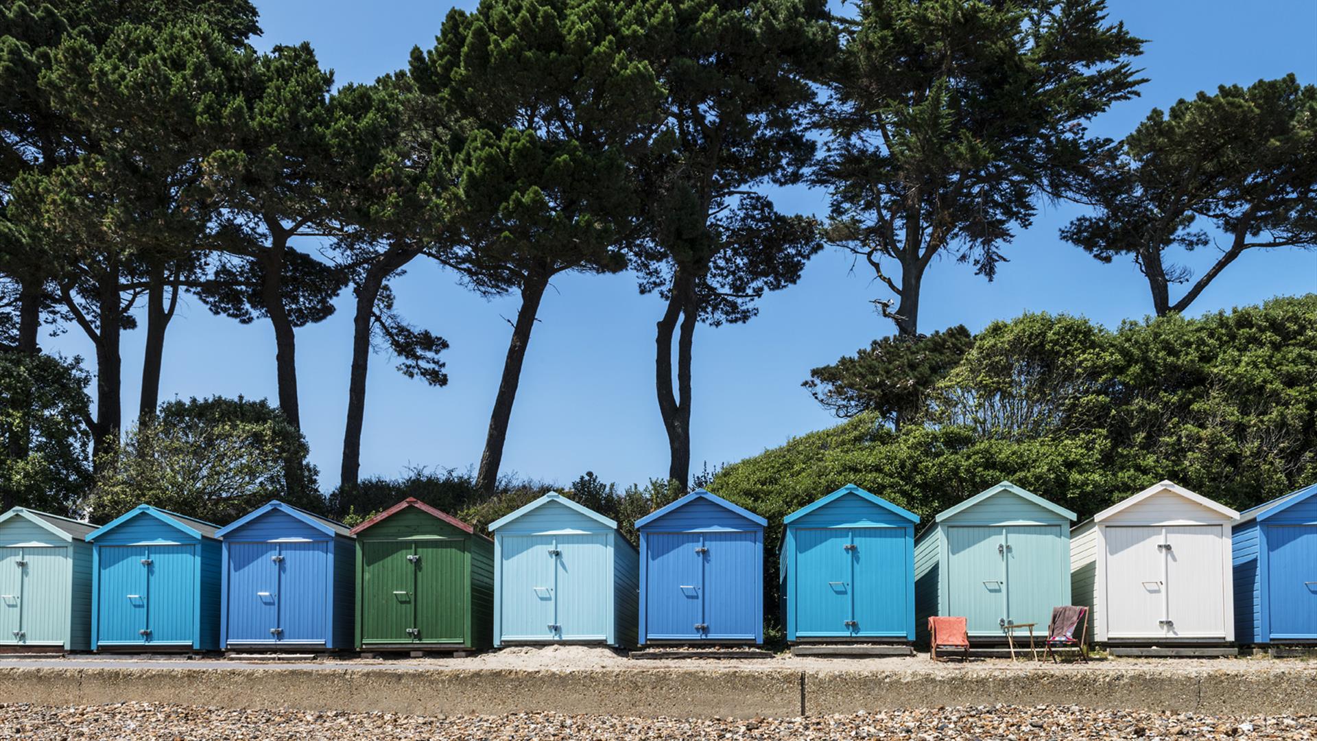 Different shades of blue and green beach huts in Christchurch