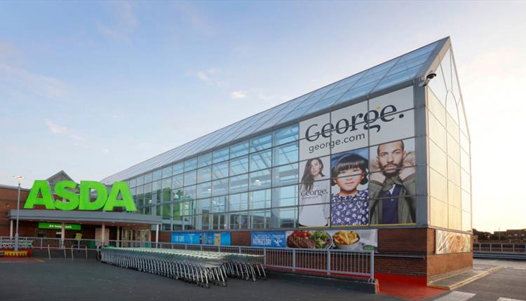 Exterior of the ASDA superstore with George clothing poster in glass atrium.