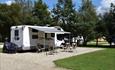 Motor home with awning and chairs ready for the summers day