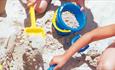 Children playing with buckets and spades