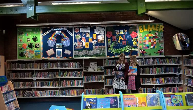 Colourful children's books and two ladies