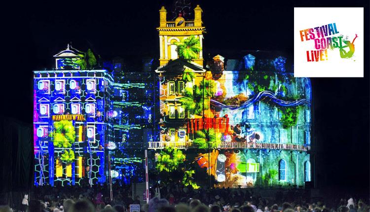 Bournemouth's town hall lit up by a projector showing amazing images and videos at night