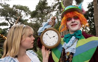 Alice and Mad Hatter with a clock