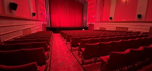 Inside the screen room with red deco red carpet and red seating