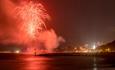 Bournemouth Friday Fireworks with red hue over the pier.
