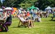 Cheese and Chilli festival attendees relaxing in the sun.
