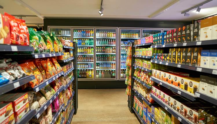 Inside a shop showing a selection of drinks and snacks