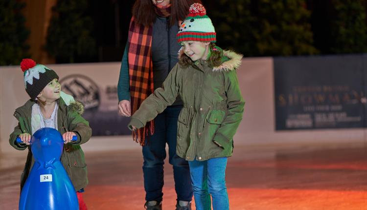 Woman and her two children enjoying a skate on the Bournemouth Ice rink