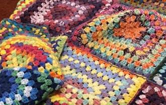 A colourful crochet blanket.