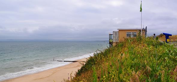View of Southbourne beach with golden sand and green cliff tops