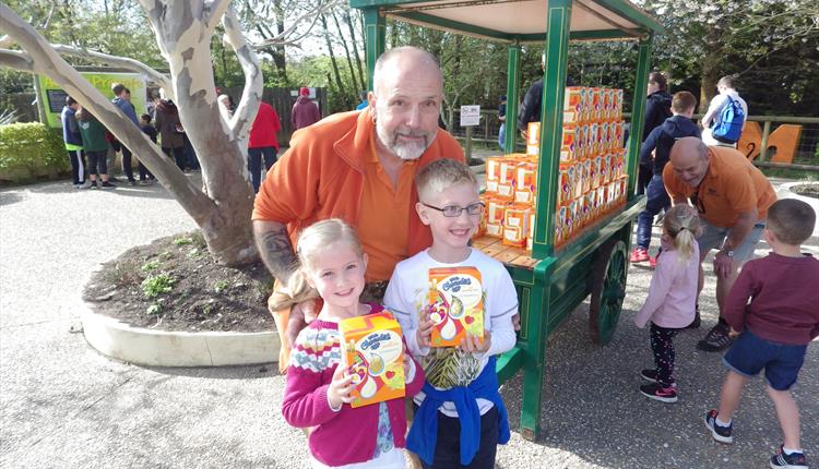 Monkey World Animal Director Jeremy Keeling with two children and Easter Eggs at the park