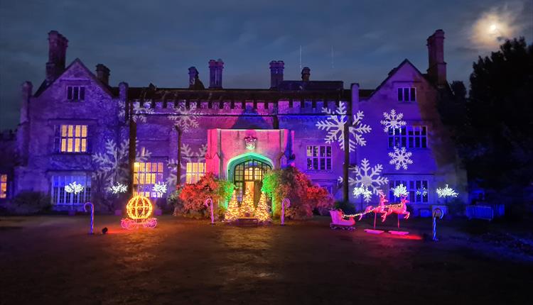 Colourful light decorations on a house with winter snow flake projections