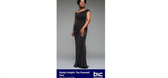 Gladys Knight in a black floor length dress smiling 
