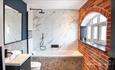 modern bathroom with exposed brick wall