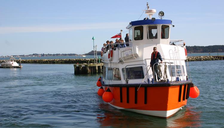 Boat filled with passengers coming into Poole Harbour
