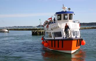 Boat filled with passengers coming into Poole Harbour