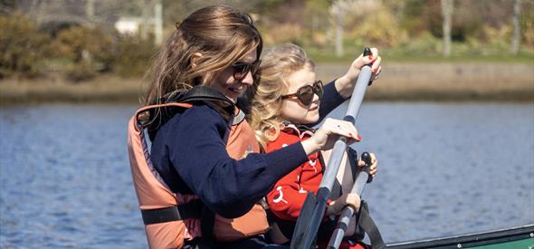 A mum canoeing along the Beaulieu River with her Daughter for Mother's Day