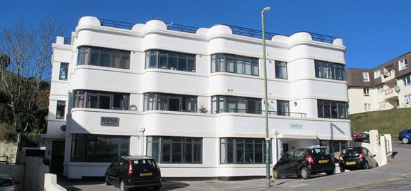 Exterior shot of the white Iona Holiday flats building from the road