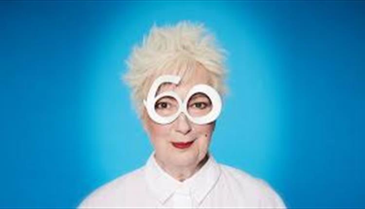 Lady with white hair, white glasses, white shirt and red lipstick