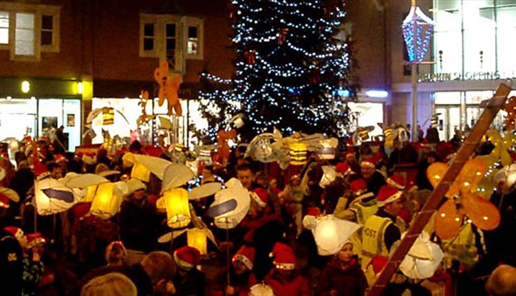 Poole residents celebrate the hanging of lanterns around the Christmas tree.