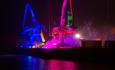 Poole harbour cranes illuminated with pink and blue lights on the Quay