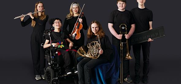 six members of the Youth Orchestra smiling with their instruments 