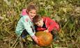 Girl and boy with a pumpkin