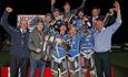 The Poole pirates speedway team celebrating their win with a massive trophy