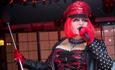 Drag Queen performing in red and black clothing