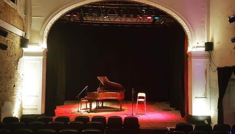 Picture of Shelley Theatre inside with piano on stage