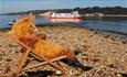 The Famous Red Squirrel Deckchair on Brownsea Island with a ferry Passing
