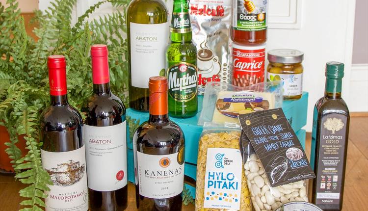 A collection of Greek food, wine and condiments