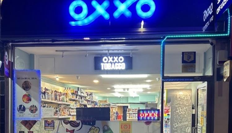 OXXO Convenience Store front with neon blue lights for the logo