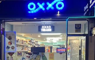 OXXO Convenience Store front with neon blue lights for the logo