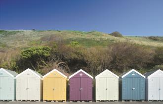 Colourful array of beach huts under the overcliff