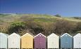 Colourful array of beach huts under the overcliff