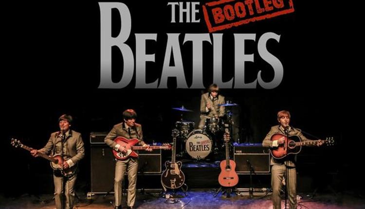 The Bootleg Beatles in Concert, beatles band performing on stage playing drums and guitars, Bootleg Beatles logo behind them on the drop down in black