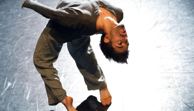dancer on stage in a deep back bend
