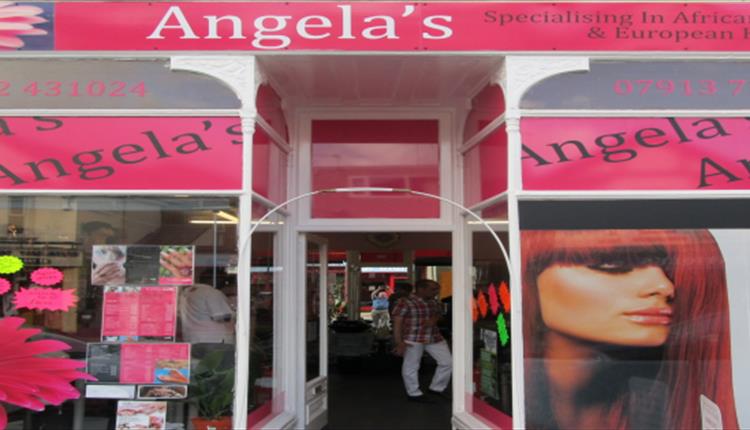 Predominantly pink shop front to Angela's Hair Salon.