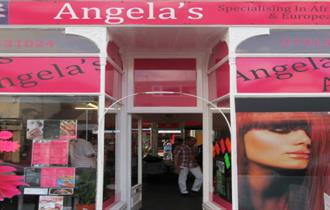 Predominantly pink shop front to Angela's Hair Salon.
