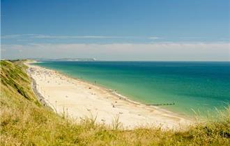 Views of southbourne beach and the blue sea taken from the overcliff on a sunny day