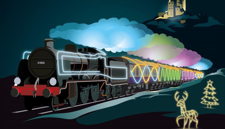 Colourful decorated illuminated steam train flying past Corfe Castle, reindeer and a Christmas tree