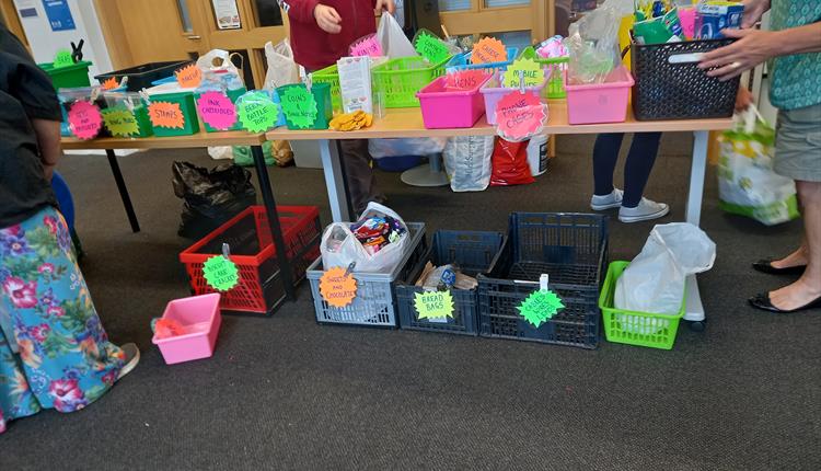 Recyclable items being collected in brightly coloured boxes.