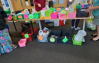 Recyclable items being collected in brightly coloured boxes.