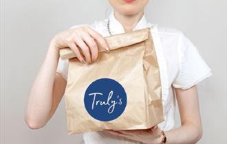 Truly's service in a paper bag