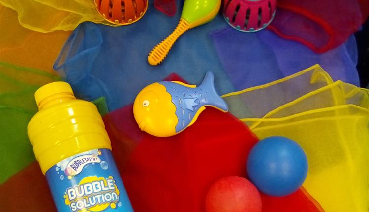 Brightly coloured scarves, noisy rattles and bubble mix for a fun Wriggle and Rhyme time.